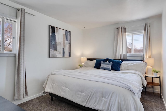 carpeted bedroom featuring baseboards