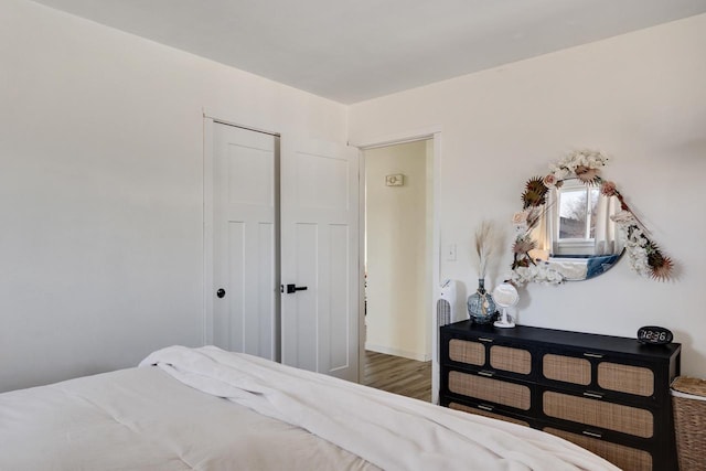 bedroom with a closet and wood finished floors