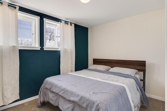 bedroom with baseboards and carpet floors