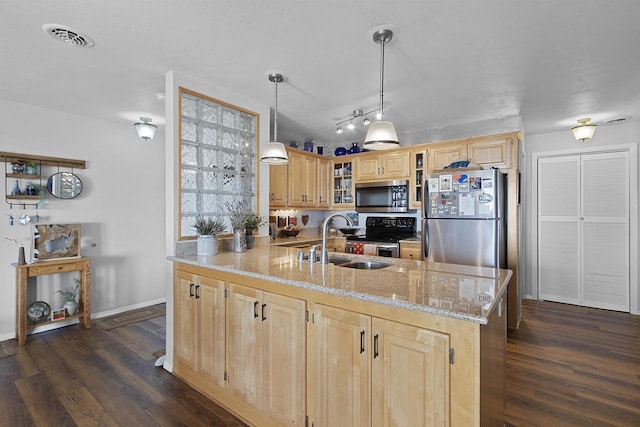 kitchen with visible vents, light brown cabinets, light stone counters, appliances with stainless steel finishes, and a sink