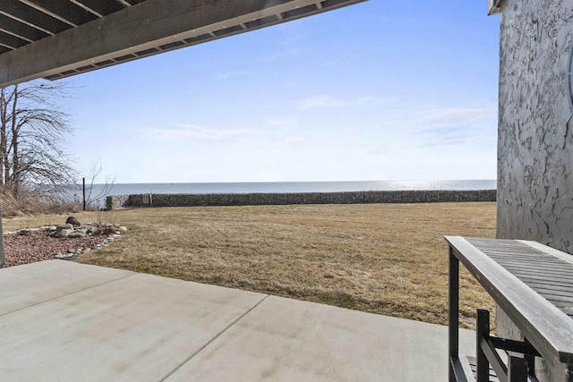 view of yard with a patio area and a water view