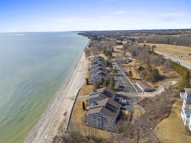 drone / aerial view with a beach view and a water view