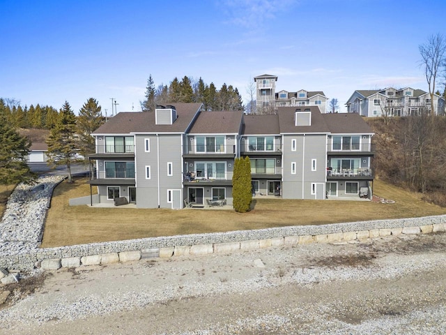 back of property with a yard and a residential view