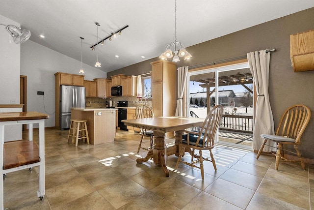 dining space featuring light tile patterned flooring, track lighting, high vaulted ceiling, and an inviting chandelier