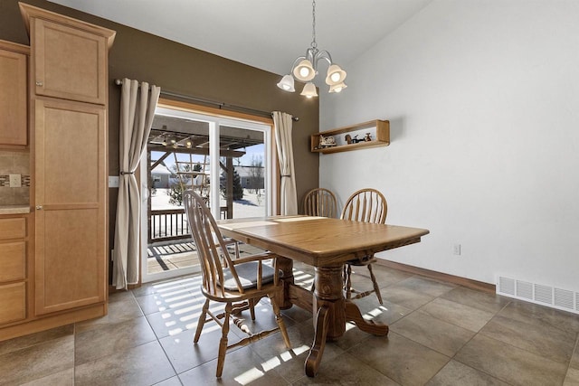 dining area with an inviting chandelier, vaulted ceiling, baseboards, and visible vents