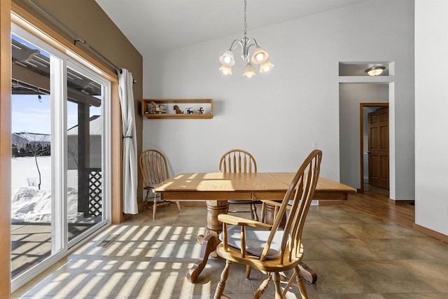 dining room with a chandelier and vaulted ceiling