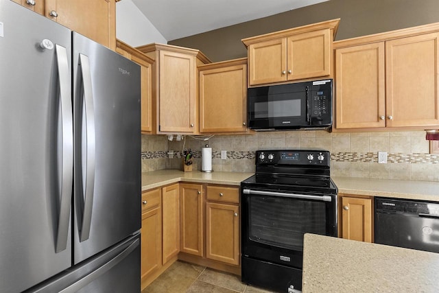 kitchen featuring light brown cabinets, light countertops, decorative backsplash, light tile patterned flooring, and black appliances