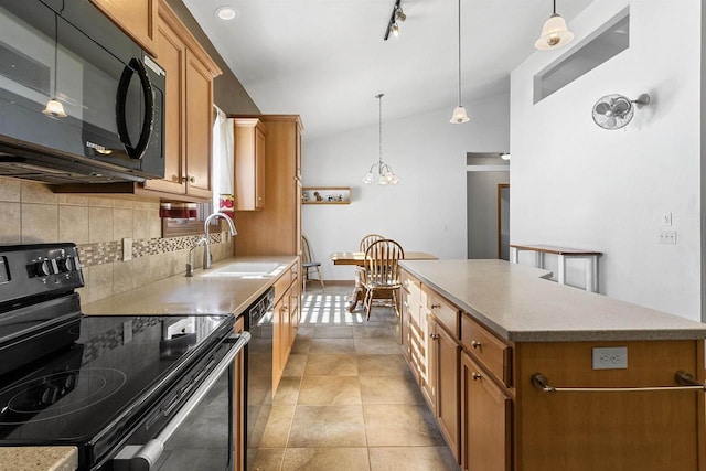 kitchen with backsplash, a center island, lofted ceiling, black appliances, and a sink