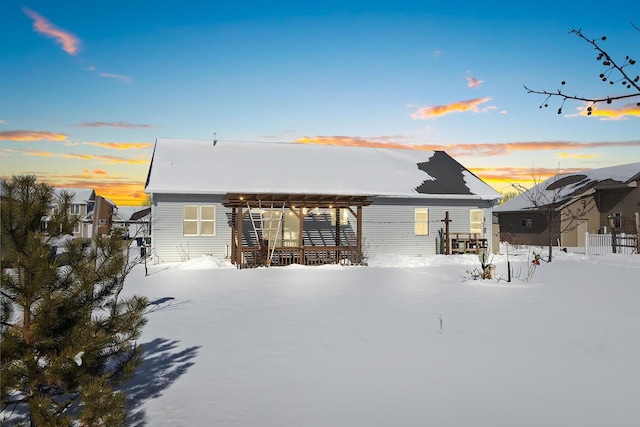 view of snow covered rear of property