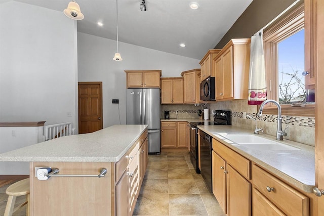 kitchen featuring pendant lighting, black appliances, a sink, a center island, and vaulted ceiling