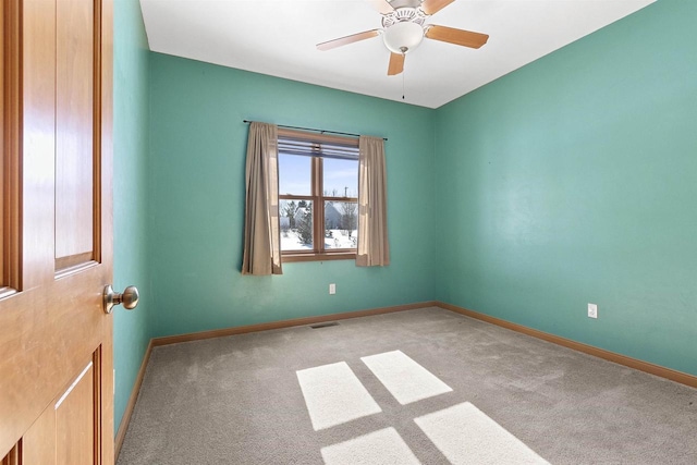 unfurnished room featuring visible vents, baseboards, carpet, and a ceiling fan