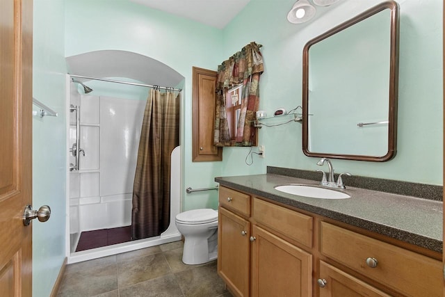 bathroom featuring curtained shower, toilet, vanity, and tile patterned flooring