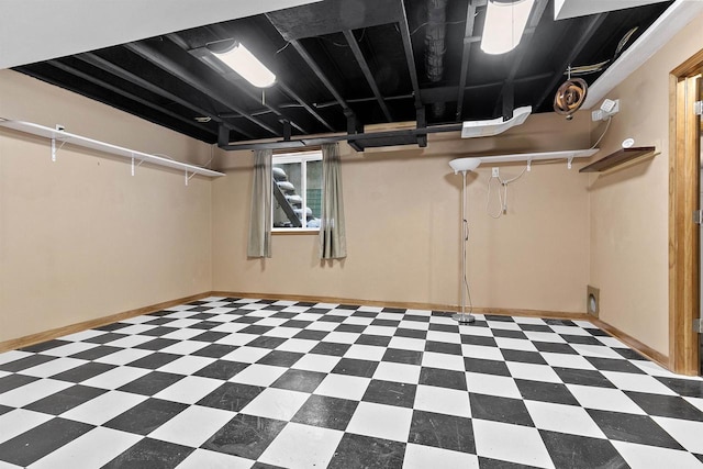 below grade area with tile patterned floors and baseboards