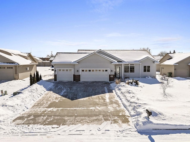 ranch-style house featuring an attached garage and driveway