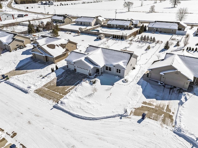 snowy aerial view with a residential view