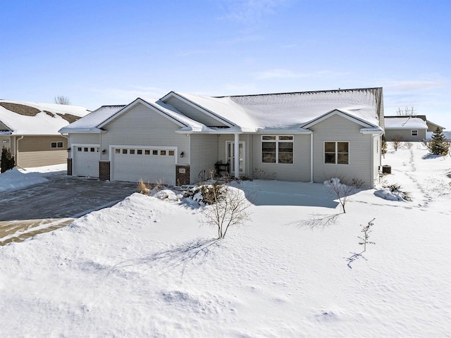 ranch-style home with an attached garage and driveway