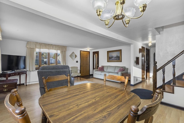 dining area with stairs, an inviting chandelier, and wood finished floors