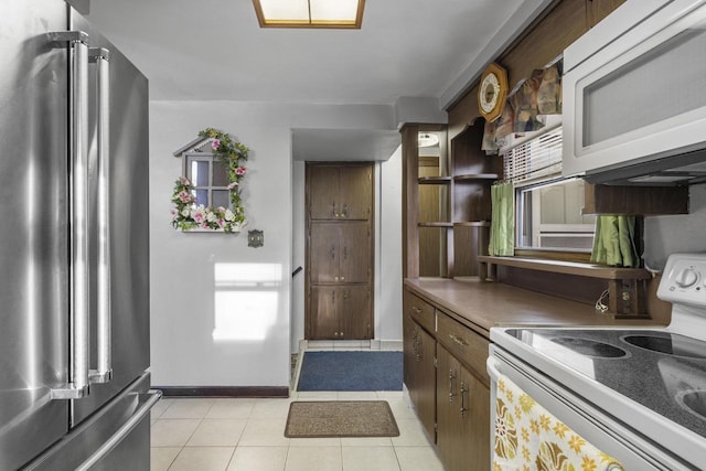 kitchen with white appliances, light tile patterned floors, baseboards, and open shelves