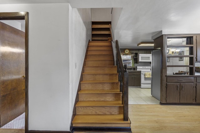 stairs featuring wood finished floors