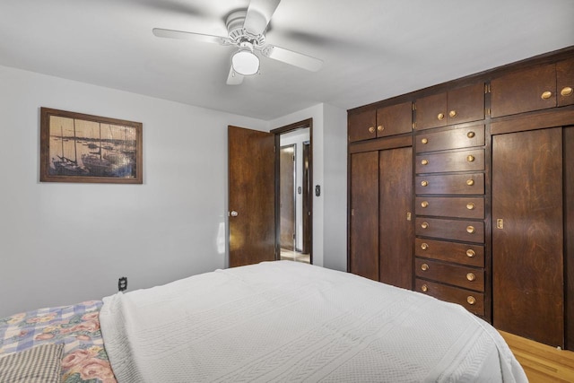 bedroom with light wood finished floors and ceiling fan