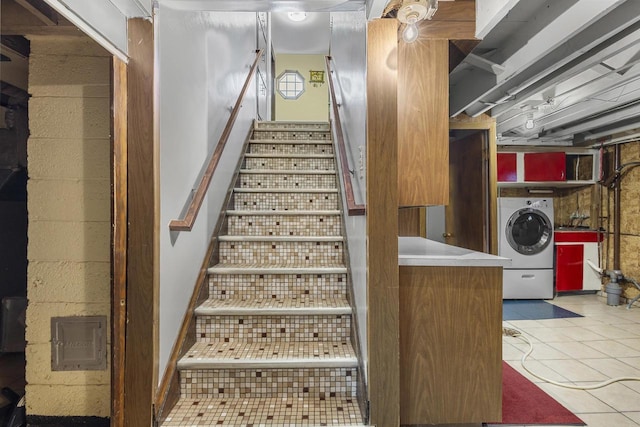 staircase featuring tile patterned flooring and washer / clothes dryer