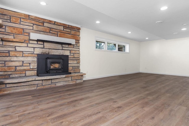 unfurnished living room with recessed lighting, baseboards, and wood finished floors