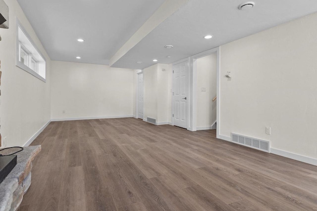 basement with visible vents, recessed lighting, baseboards, and wood finished floors