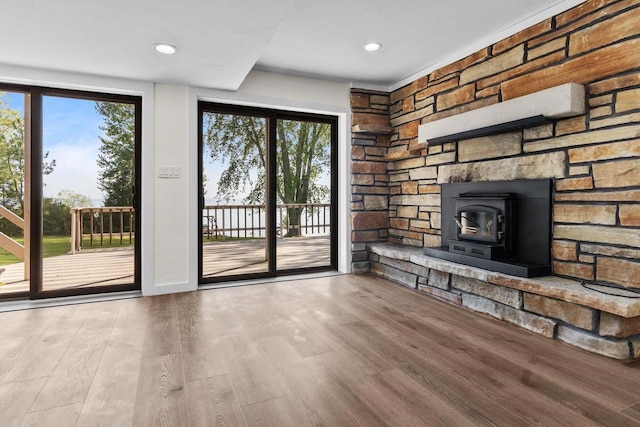 unfurnished living room featuring a wealth of natural light, recessed lighting, and wood finished floors