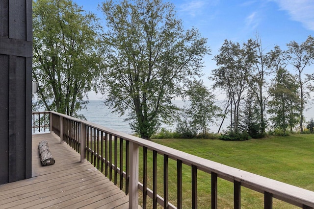 wooden deck featuring a water view and a lawn