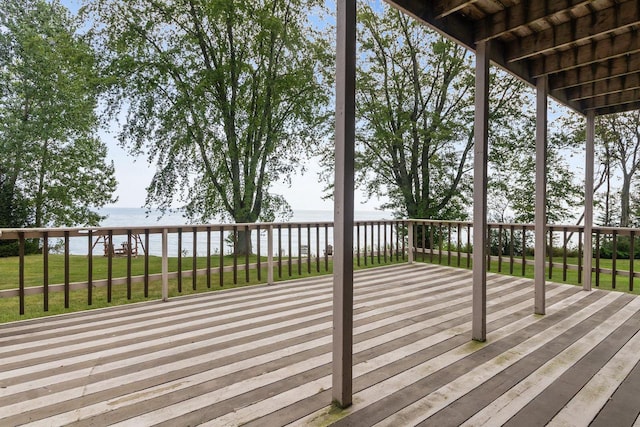 wooden terrace with a lawn and a water view