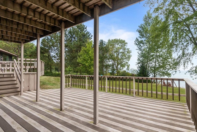 wooden deck featuring a yard