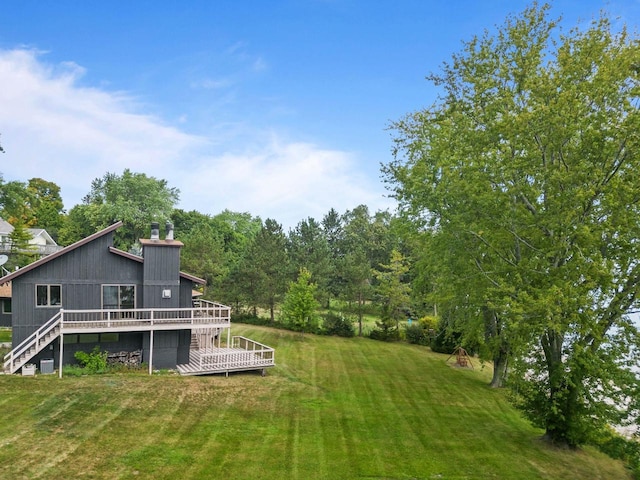 view of yard with a wooden deck and stairs