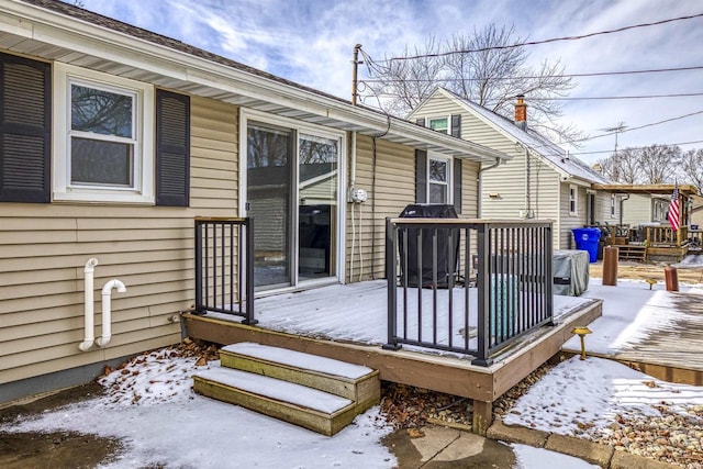 snow covered deck featuring area for grilling