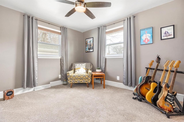 sitting room featuring carpet flooring, baseboards, visible vents, and a ceiling fan