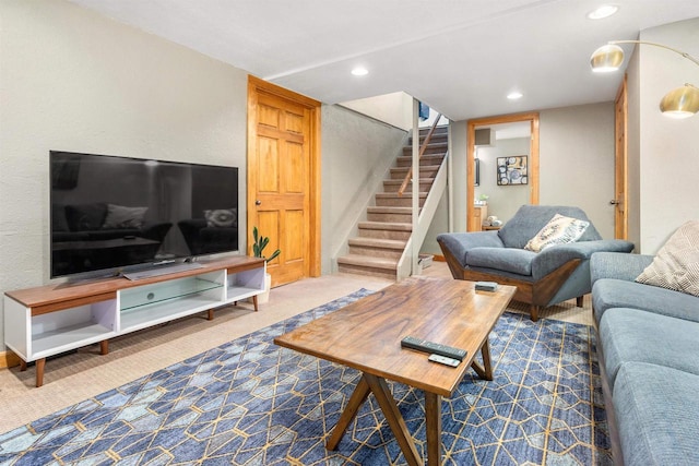 carpeted living room with recessed lighting and stairs