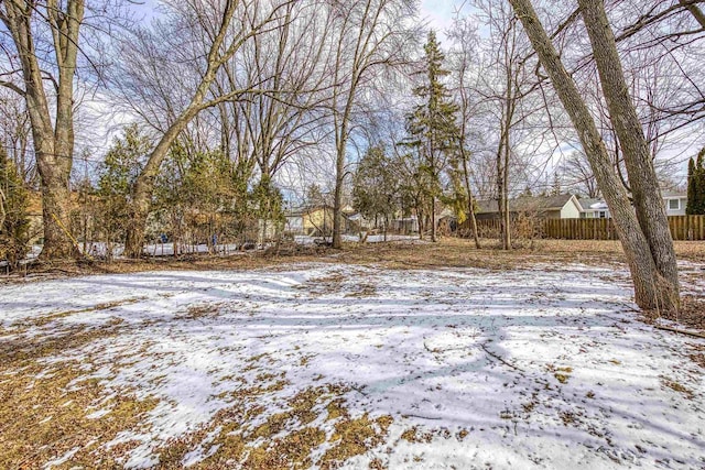 snowy yard with fence