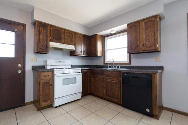 kitchen featuring under cabinet range hood, a sink, gas range gas stove, black dishwasher, and dark countertops