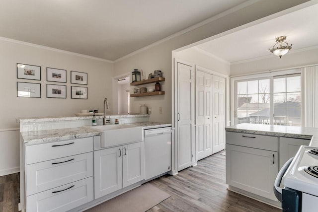 kitchen featuring white appliances, a peninsula, open shelves, and ornamental molding