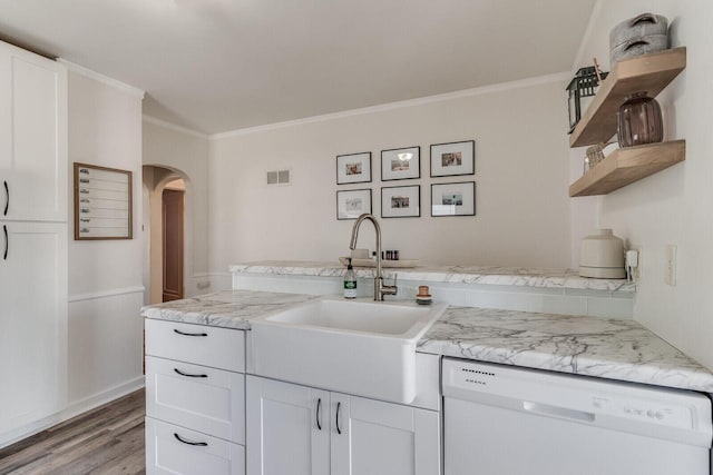 kitchen with dishwasher, open shelves, arched walkways, and white cabinetry