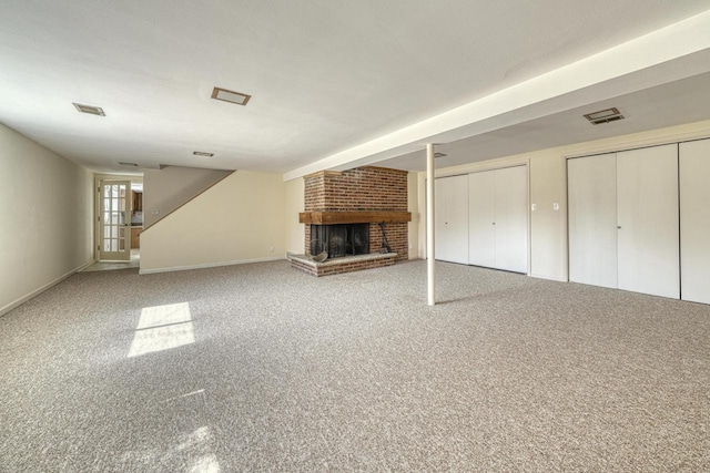 unfurnished living room featuring visible vents, baseboards, carpet, and a brick fireplace