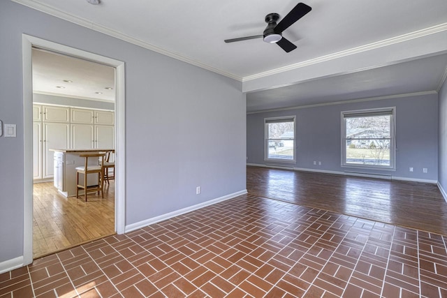 unfurnished room featuring baseboards, ornamental molding, and a ceiling fan