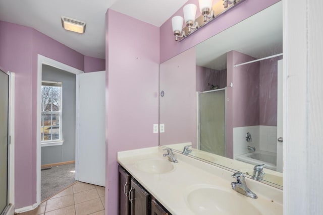 full bathroom with a sink, visible vents, a shower with shower door, and tile patterned flooring