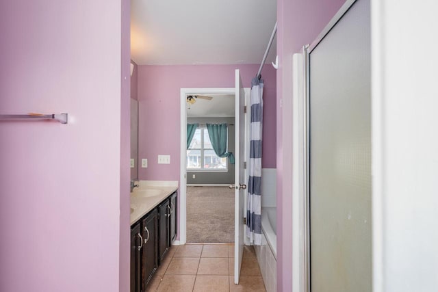 full bath featuring a ceiling fan, shower / tub combo with curtain, vanity, and tile patterned flooring