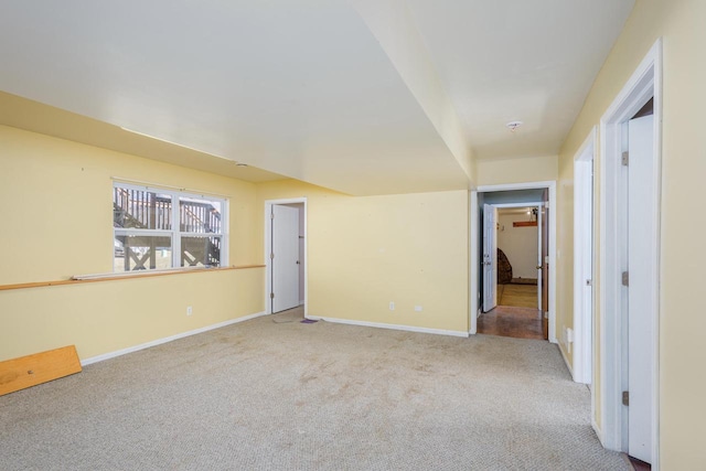 empty room featuring baseboards and carpet