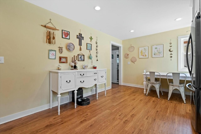 dining room with recessed lighting, baseboards, and light wood-style flooring