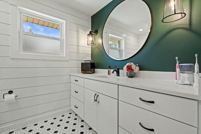 bathroom featuring wooden walls and vanity