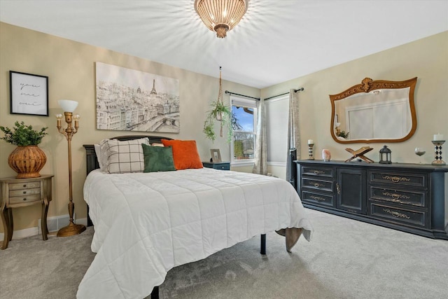 bedroom with baseboards and carpet