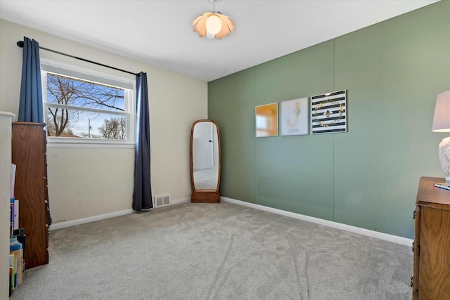 unfurnished bedroom featuring visible vents, baseboards, and carpet