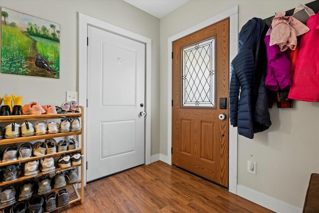 entryway with baseboards and wood finished floors