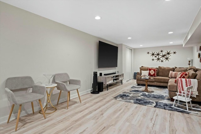 living area with recessed lighting, wood finished floors, and baseboards